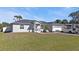 Inviting single-story home with a well-manicured lawn, RV parking, and a charming front porch at 11338 Willmington Blvd, Port Charlotte, FL 33981