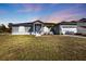 Beautifully kept home features a lawn and clean exterior with parking for an RV or boat at 11338 Willmington Blvd, Port Charlotte, FL 33981