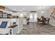 Modern kitchen and dining area with stainless steel appliances, granite countertops and wood-style flooring at 11338 Willmington Blvd, Port Charlotte, FL 33981