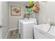 Well-equipped laundry room with white washer, dryer, and utility sink at 11338 Willmington Blvd, Port Charlotte, FL 33981