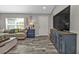 Cozy living room featuring modern flooring, neutral walls, ample seating, and natural light at 11338 Willmington Blvd, Port Charlotte, FL 33981