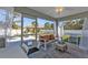 Screened-in porch with comfortable seating and serene backyard views at 11338 Willmington Blvd, Port Charlotte, FL 33981
