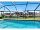 Inviting screened pool with views of the boat dock and waterfront homes on a sunny day at 1316 Monte Carlo Ct, Punta Gorda, FL 33950