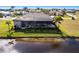 Beautiful aerial view of the property showing the screened pool, landscaping, and waterfront location at 17122 Barcrest Ln, Punta Gorda, FL 33955