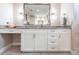 Bathroom vanity features white cabinets, granite countertop, modern lighting, and a makeup area with a comfortable stool at 17122 Barcrest Ln, Punta Gorda, FL 33955