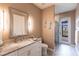 Elegant bathroom with a marble countertop, modern vanity, and a glass-enclosed shower with outdoor access at 17122 Barcrest Ln, Punta Gorda, FL 33955