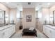 Elegant bathroom featuring dual vanities, marble countertops, and large walk-in showers with neutral tile and mosaic accents at 17122 Barcrest Ln, Punta Gorda, FL 33955