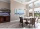 Dining room with glass table, wood chairs, custom lighting, and serving area with wine storage at 17122 Barcrest Ln, Punta Gorda, FL 33955