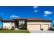 Charming single-story home featuring a tile roof, three-car garage, and well-manicured landscaping at 17122 Barcrest Ln, Punta Gorda, FL 33955