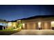 Charming, single-story home with a well-manicured lawn, paved driveway, and a two-car garage at dusk at 17122 Barcrest Ln, Punta Gorda, FL 33955