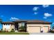 Beautiful home featuring a three-car garage, manicured landscaping, and a neutral color palette at 17122 Barcrest Ln, Punta Gorda, FL 33955