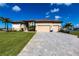 Charming single-Gathering home featuring a three-car garage, paved driveway, and well-maintained lawn at 17122 Barcrest Ln, Punta Gorda, FL 33955