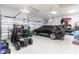 Spacious three car garage with a golf cart, an SUV, and epoxy-coated floors, perfect for car enthusiasts at 17122 Barcrest Ln, Punta Gorda, FL 33955