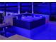 Relaxing hot tub adjacent to the pool with decorative stone and ambient lighting at 17122 Barcrest Ln, Punta Gorda, FL 33955