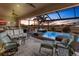 Inviting outdoor patio area with comfortable seating and views of the sparkling pool and backyard at 17122 Barcrest Ln, Punta Gorda, FL 33955