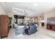 Open-concept living room with tile flooring, tray ceiling, and seamless access to the outdoor patio at 17122 Barcrest Ln, Punta Gorda, FL 33955