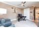 Inviting home office featuring a ceiling fan, nautical decor, and a comfortable seating area with natural light at 17122 Barcrest Ln, Punta Gorda, FL 33955