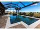 Beautiful pool and lanai area featuring a screened enclosure, outdoor seating, and waterfront views on a sunny day at 17122 Barcrest Ln, Punta Gorda, FL 33955