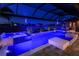Relaxing private pool and spa area at night, featuring ambient lighting, screened enclosure, and outdoor furniture at 17122 Barcrest Ln, Punta Gorda, FL 33955