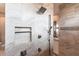 Spacious walk-in shower featuring neutral tiling, multiple shower heads, and a convenient built-in storage niche at 17122 Barcrest Ln, Punta Gorda, FL 33955