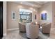 A cozy sitting area with neutral-toned swivel chairs and a view of the screened-in lanai at 17122 Barcrest Ln, Punta Gorda, FL 33955
