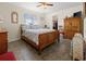 Cozy bedroom features wood floors, a ceiling fan, and natural light at 188 Cypress Nw Ave, Port Charlotte, FL 33952