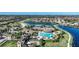 Aerial view of community with a resort-style pool, clubhouse, and lush landscaping at 20272 Lagente, Venice, FL 34293