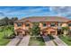 Beautiful townhome exterior showcasing a tile roof, brick driveway, and a two car garage at 20272 Lagente, Venice, FL 34293