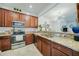 Well-equipped kitchen featuring granite countertops, stainless steel appliances, and wooden cabinetry at 20272 Lagente, Venice, FL 34293