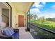 Outdoor patio area with seating provides a serene view of the manicured lawn at 20272 Lagente, Venice, FL 34293