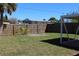 Backyard featuring a privacy fence and a tall tree at 21456 Holdern Ave, Port Charlotte, FL 33952