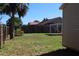 Backyard featuring a privacy fence and a tall tree at 21456 Holdern Ave, Port Charlotte, FL 33952