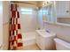 Bathroom featuring a bathtub, tiled wall, shower head, vanity, and patterned shower curtain at 21456 Holdern Ave, Port Charlotte, FL 33952
