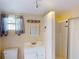 Well-lit bathroom featuring a vanity, medicine cabinet, window, and shower with sliding doors at 21456 Holdern Ave, Port Charlotte, FL 33952