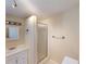 Bathroom features single sink vanity and standing shower with glass door at 21456 Holdern Ave, Port Charlotte, FL 33952