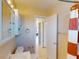 Bathroom featuring a sink, mirror, towel rack, door and a glimpse into the hallway at 21456 Holdern Ave, Port Charlotte, FL 33952