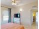 Bedroom with tile floors and view to en-suite bathroom at 21456 Holdern Ave, Port Charlotte, FL 33952
