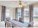 Dining room featuring a ceiling fan, a dining table set, and views of the outside at 21456 Holdern Ave, Port Charlotte, FL 33952