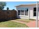 Exterior of home features a wooden fence and multiple windows at 21456 Holdern Ave, Port Charlotte, FL 33952
