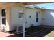 Exterior shot of a home with a covered patio, exterior door, gas meter and AC unit at 21456 Holdern Ave, Port Charlotte, FL 33952