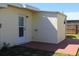 A home's exterior features updated windows and an outdoor patio area at 21456 Holdern Ave, Port Charlotte, FL 33952