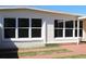 A home's exterior features updated windows and decorative grass details at 21456 Holdern Ave, Port Charlotte, FL 33952