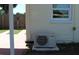 HVAC unit next to the house exterior and wooden fence in the background at 21456 Holdern Ave, Port Charlotte, FL 33952