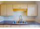 Neutral kitchen featuring light wood cabinets and a double stainless steel sink at 21456 Holdern Ave, Port Charlotte, FL 33952
