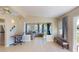 Open living room featuring neutral tile flooring and an adjacent sitting area at 21456 Holdern Ave, Port Charlotte, FL 33952
