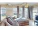 Spacious living room featuring a comfortable sectional sofa, abundant natural light, and access to the dining area at 21456 Holdern Ave, Port Charlotte, FL 33952