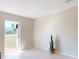 Neutral living room featuring tile flooring and a door leading to the outdoors at 21456 Holdern Ave, Port Charlotte, FL 33952