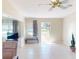 Bright and airy living room featuring tile floors, neutral paint, and large windows with views of the outdoors at 21456 Holdern Ave, Port Charlotte, FL 33952