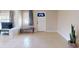 Neutral living room featuring tile flooring, a front entrance, and neutral decor at 21456 Holdern Ave, Port Charlotte, FL 33952