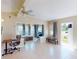 Bright living space with tile flooring, a comfortable chair, desk, and views into the living room and front entrance at 21456 Holdern Ave, Port Charlotte, FL 33952
